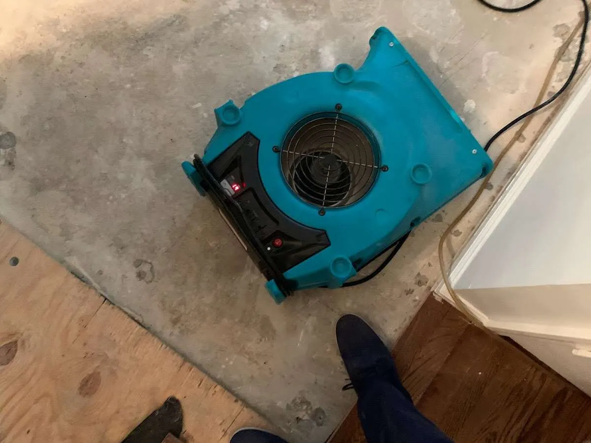Air mover drying subfloor during Commercial Water Damage Restoration in Alpharetta